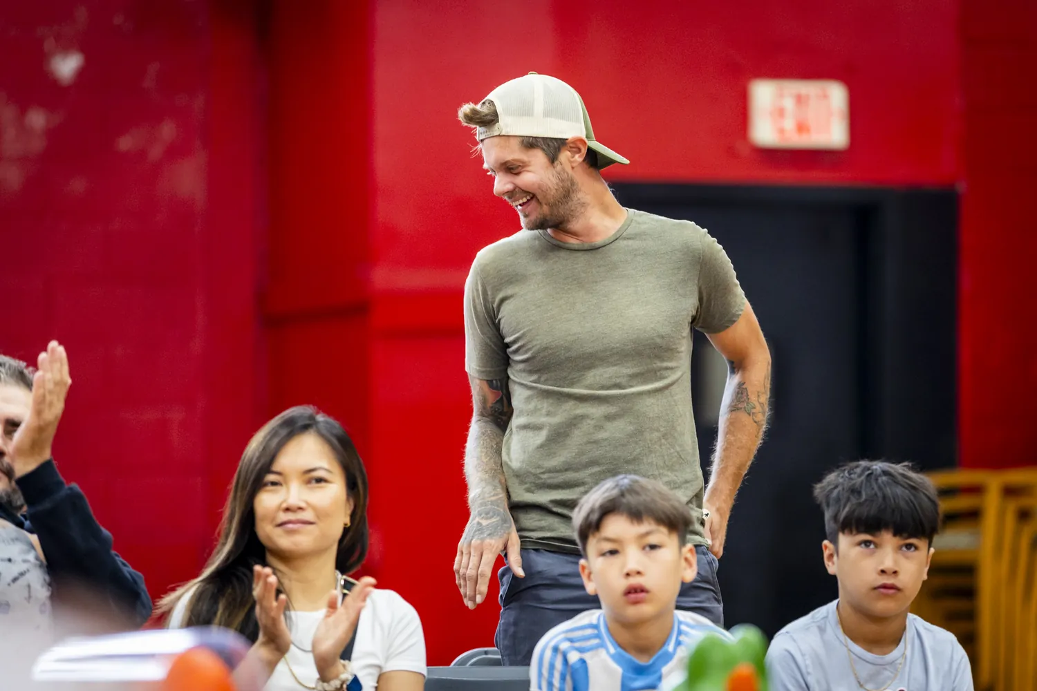 A family cheering from the sidelines