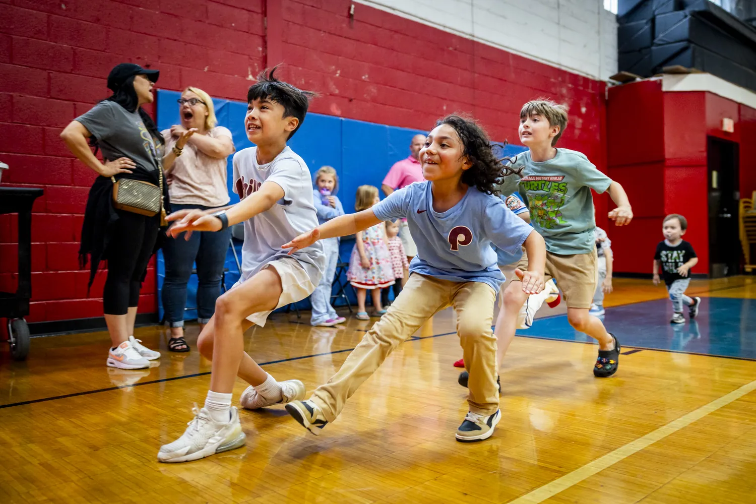 Kids sprinting across the gym floor