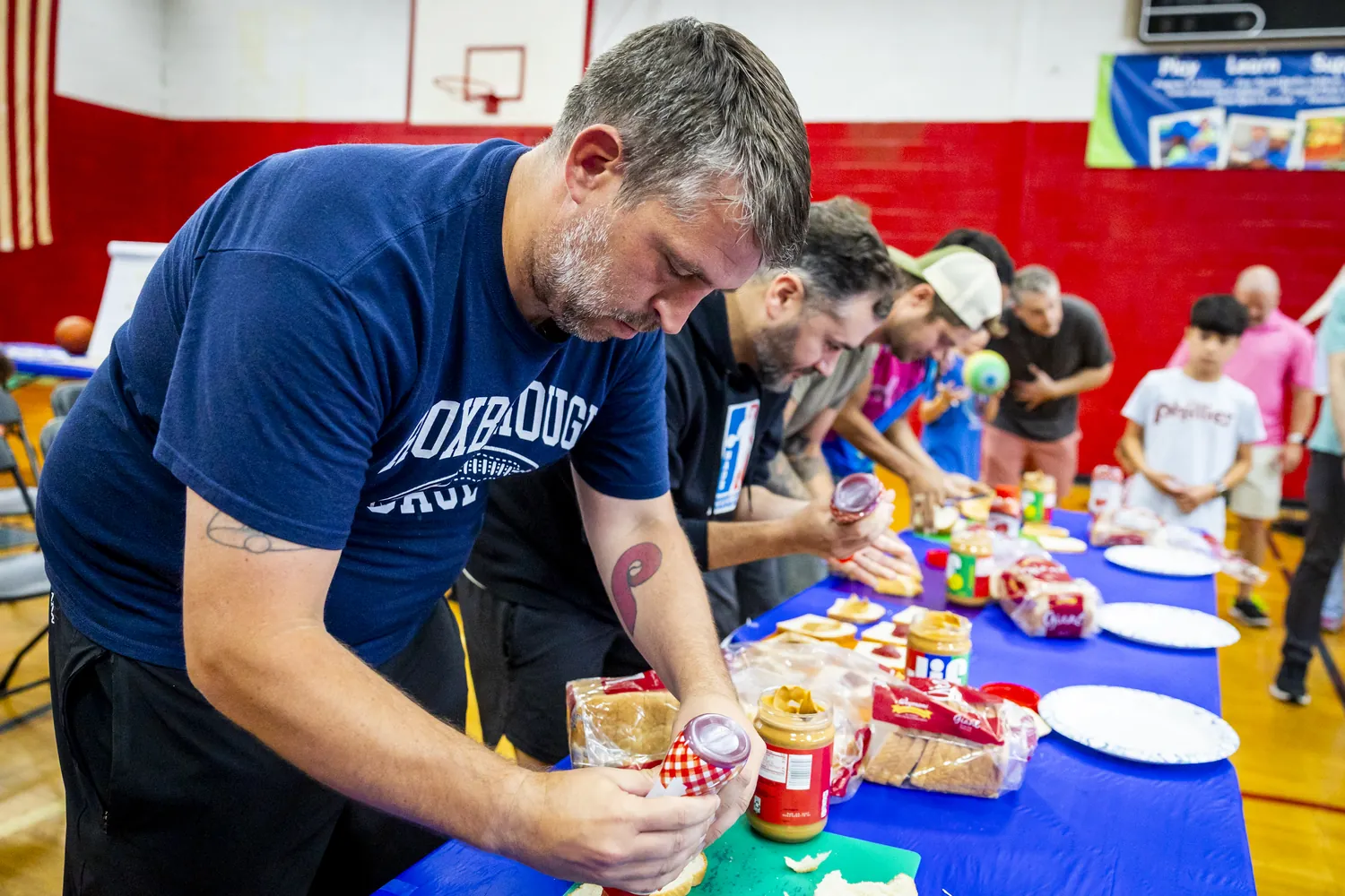 A dad spreading peanut butter during a sandwich-making race